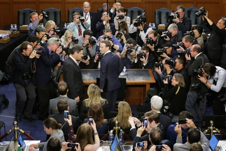 Facebook CEO Mark Zuckerberg (C) faced tough questions about trustworthiness over the company's handling of users' personal data