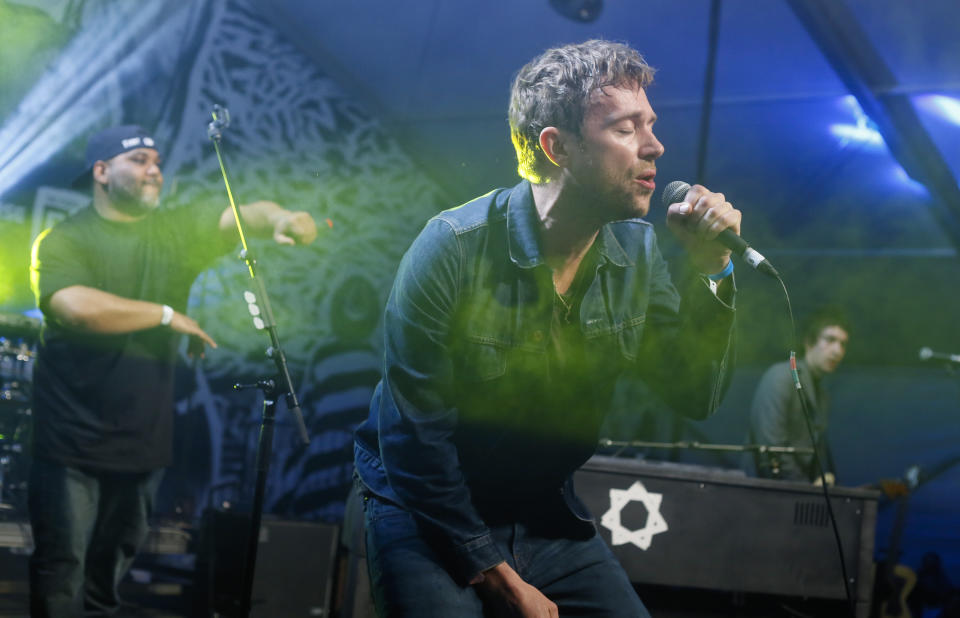 FILE - In this March 14, 2014 file photo, Damon Albarn, right, joined by De La Soul's Vincent Mason, left, performs during the SXSW Music Festival in Austin, Texas. Albarn's new album, "Everyday Robots," released on Monday, April 28, 2014. (Photo by Jack Plunkett/Invision/AP, file)