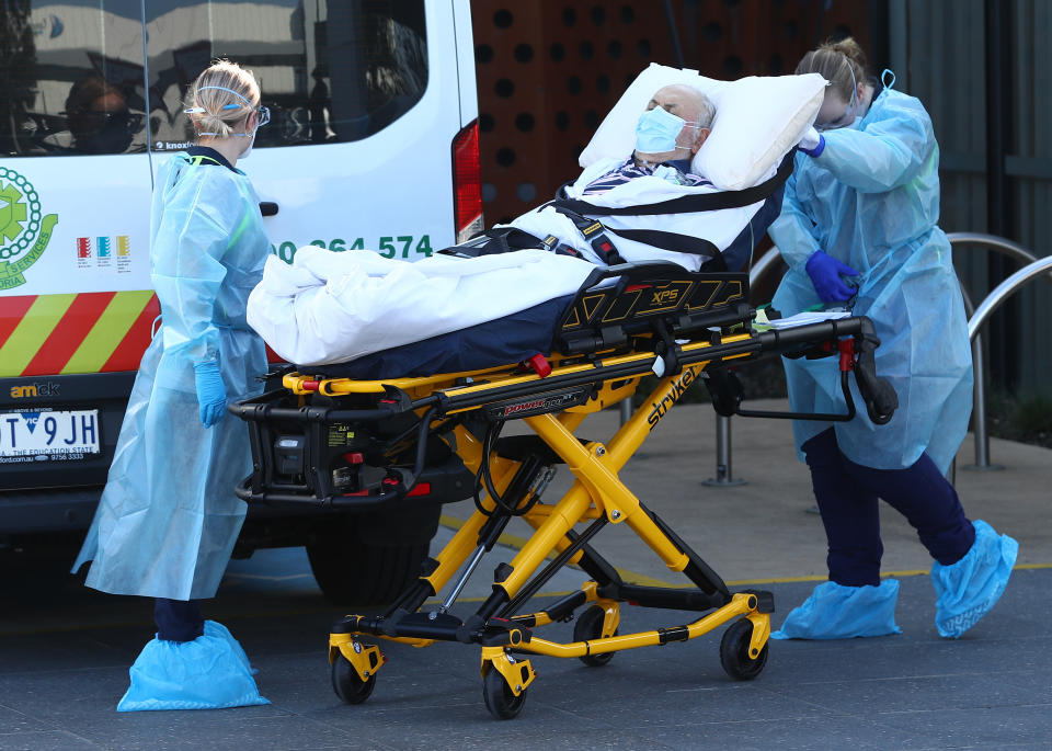 MELBOURNE, AUSTRALIA - JULY 29: A resident is taken from the Epping Hardens Aged Care Home on July 29, 2020 in Melbourne, Australia. More than 150 people have been moved from aged care homes to hospitals as Victoria reports 382 new COVID-19 cases and six deaths. Metropolitan Melbourne and the Mitchell shire remain in lockdown due to the rise in COVID-19 cases through community transmissions, with people permitted to leave home only for exercise, work, to buy essential items, or to access childcare and healthcare and individuals are required Face coverings or be subject to a $200 fine. Lockdown measures are in place until August 19. (Photo by Robert Cianflone/Getty Images)