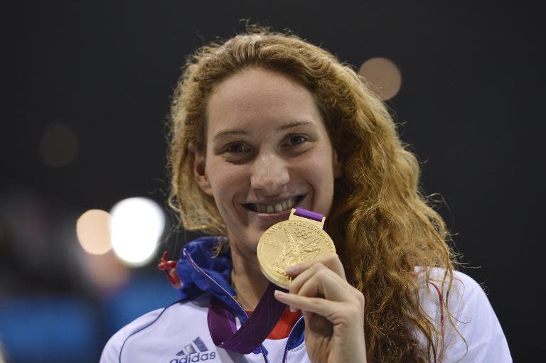 France's gold medalist Camille Muffat celebrates on the podium after winning the women's 400m freestyle swimming event at the London 2012 Olympic Games on July 29, 2012