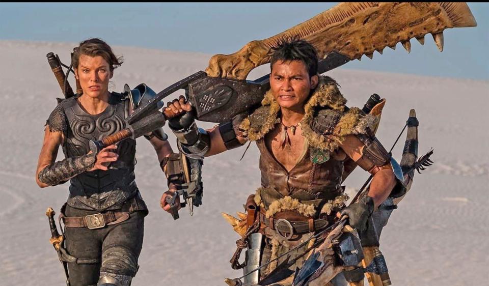 Milla Jovovich and Tony Jaww rock out in medieval swag in "Monster Hunter"