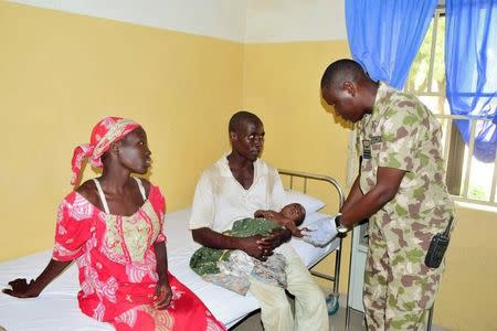 Rescued Chibok schoolgirl Amina Ali Darsha Nkeki, her husband and baby are attended to in a hospital in Maiduguri, Borno state, Nigeria in this handout received May 19, 2016. Nigeria Military/Handout via REUTERS