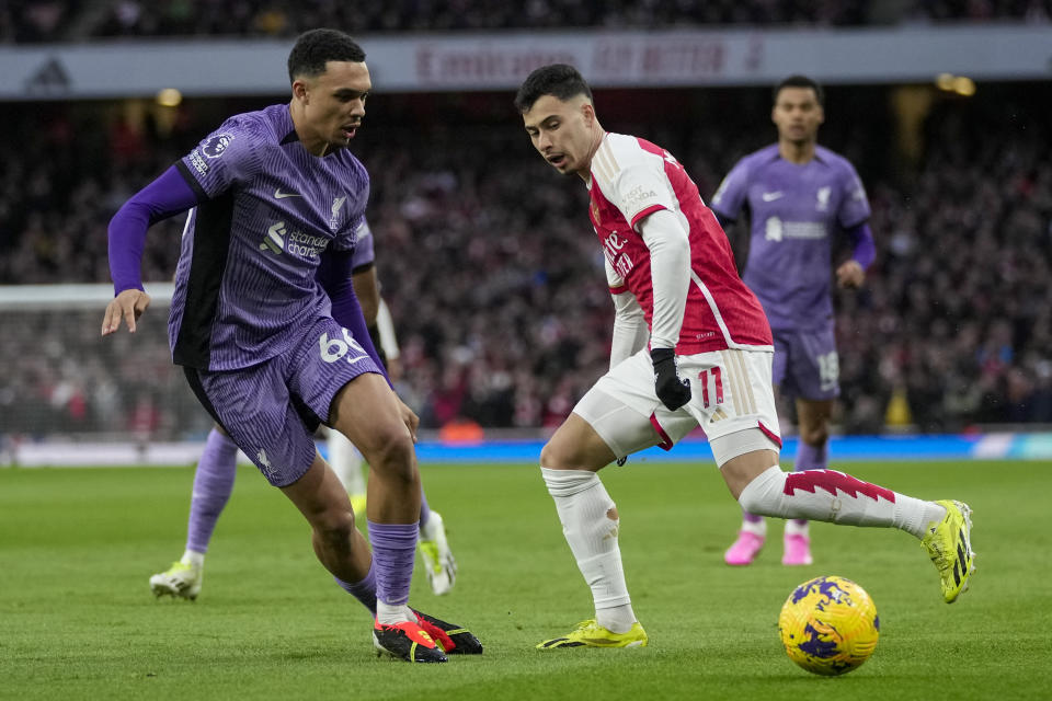 Liverpool's Trent Alexander-Arnold, left, and Arsenal's Gabriel Martinelli fight for the ball during the English Premier League soccer match between Arsenal and Liverpool at Emirates Stadium in London,, Sunday, Feb. 4, 2024. (AP Photo/Kin Cheung)