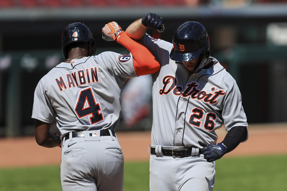 Detroit Tigers' C.J. Cron (26) celebrates with Cameron Maybin (4) after hitting a two-run home run in the ninth inning during a baseball game against the Detroit Tigers at Great American Ballpark in Cincinnati, Sunday, July 26, 2020. (AP Photo/Aaron Doster)