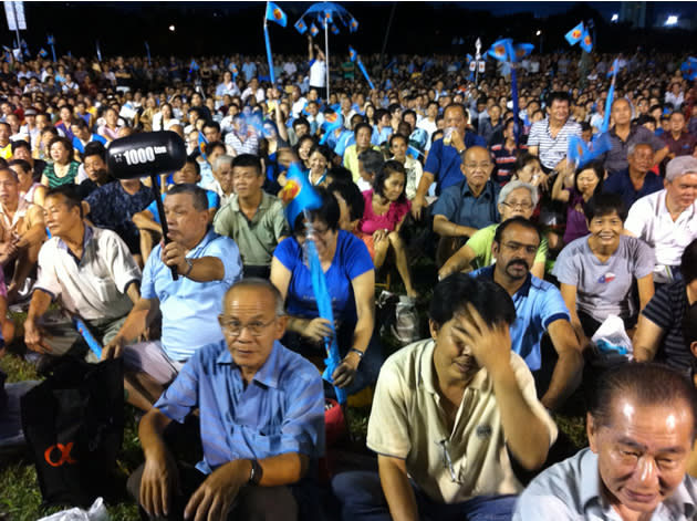 Armed with cardboard boxes, flags, umbrellas, and whistles, elderly supporters of the WP stay upbeat despite the humid night. (Yahoo! photo)