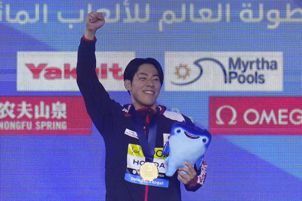 Tomoru Honda of Japan celebrates after winning the gold medal in the men's 200m butterfly final at the World Aquatics Championships in Doha, Qatar, Wednesday, Feb. 14, 2024. (AP Photo/Hassan Ammar)