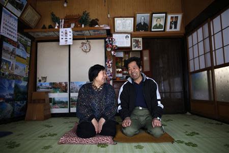 Toshio Koyama, 72, and his wife Kimiko, 69, who evacuated from the Miyakoji area of Tamura three years ago, smile after they returned to their home in Tamura, Fukushima prefecture April 1, 2014. REUTERS/Issei Kato