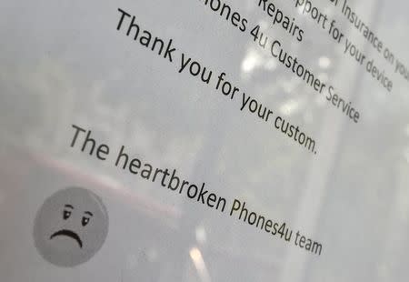 The detail of a printed message is seen on a branch of Phones 4u in west London, September 15, 2014. REUTERS/Toby Melville