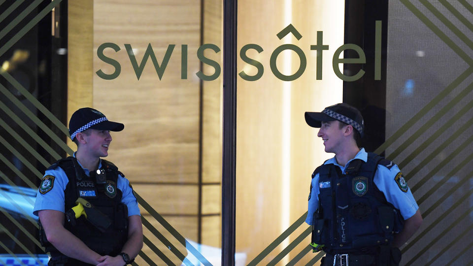 NSW Police stand guard outside the Swissotel Hotel.