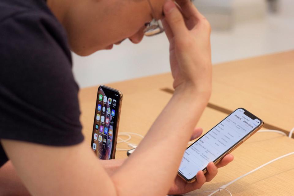 A customer looks at the new iPhone XS Max at an Apple store. The company's new software has introduced new features that can monitor and prevent social media addiction: AP/Patrick Sison