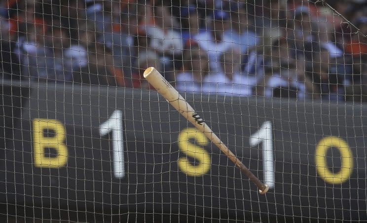 A bat that slipped out of the hands of San Francisco Giants' Buster Posey hangs from the netting behind home plate in the second inning of a baseball game against the Los Angeles Dodgers, Saturday, June 11, 2016, in San Francisco. (AP Photo/Ben Margot)