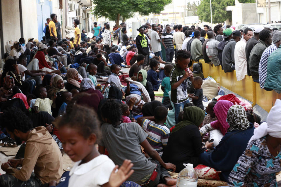 FILE - In this Oct. 9, 2021 file photo, dozens of migrants protest, in front of the office of the United Nation's humanitarian body in Tripoli, Libya. The United Nations says it has resumed humanitarian evacuation flights for migrants stranded in Libya. The announcement comes after a massive crackdown on migrants inside the country and the suspension of the flights for several months. (AP Photo/Yousef Murad, File)