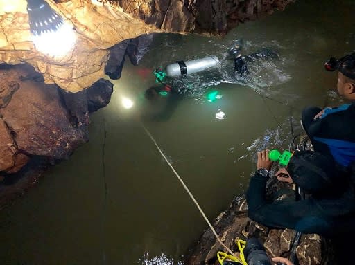 Rescue divers continue to fight against muddy, fast-flowing waters while water pumps work around the clock to try and keep water levels down