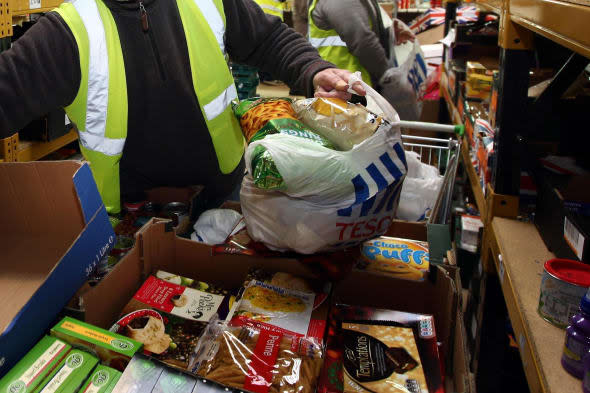 File photo dated 20/12/11 of workers at a Food Bank. More than a third of all councils in England and Wales are subsidising food banks - setting aside almost ?3 million in recent years, an investigation has found. PRESS ASSOCIATION Photo. Issue date: Monday March 3, 2014. The local authorities have set aside ?2.9 million of public money over the last couple of years to combat food poverty, according to BBC Panorama. While the Government says that food banks are not part of the welfare system, the programme asked all 375 councils in England and Wales about food banks and 323 responded, and of those, 140 said they were providing funding. See PA story POLITICS Foodbanks. Photo credit should read: David Jones/PA Wire