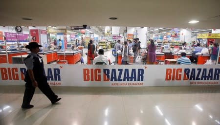 FILE PHOTO: A security personnel walks past the Big Bazaar retail store in Mumbai