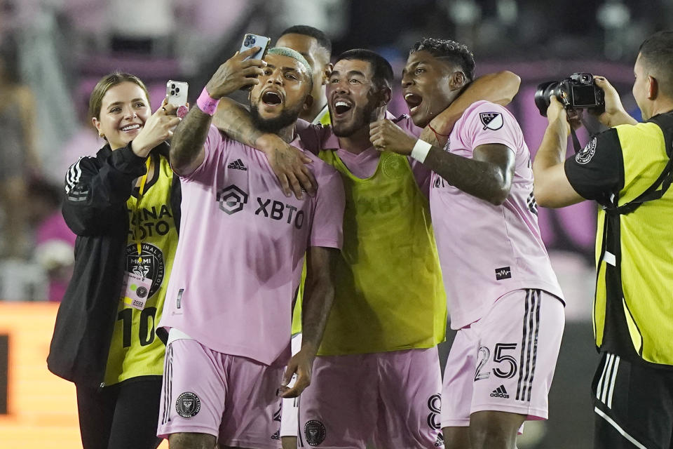 Inter Miami defender DeAndre Yedlin takes a photo with teammate, including Emerson Rodríguez (25), at the end of an MLS soccer match against Charlotte FC, Saturday, July 16, 2022, in Fort Lauderdale, Fla. (AP Photo/Marta Lavandier)