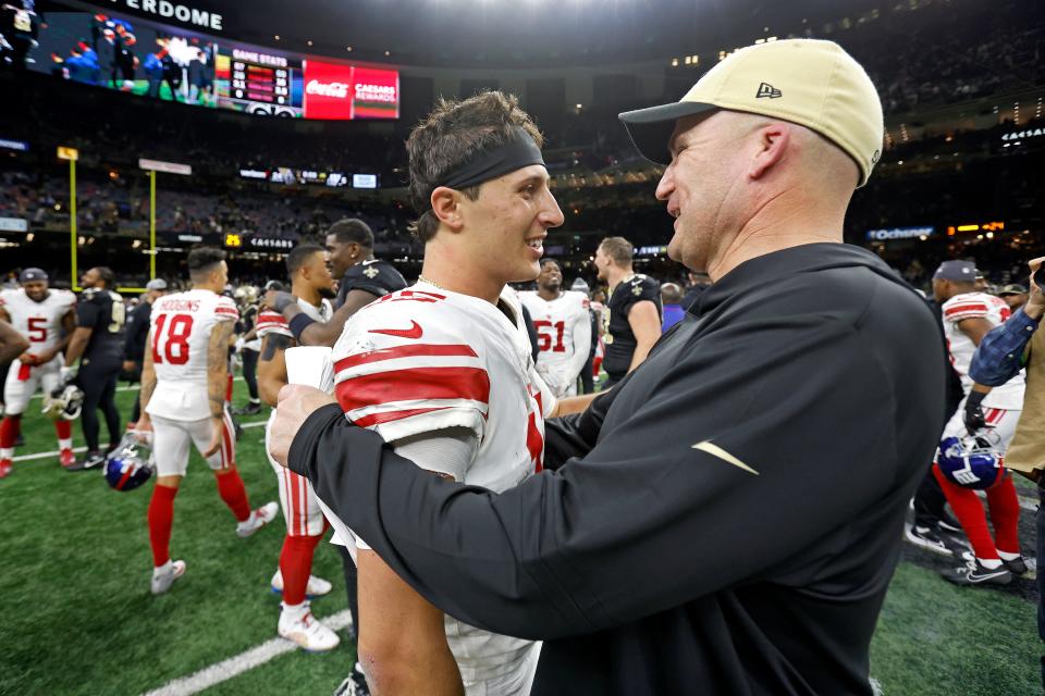 New Orleans Saints special teams coordinator Darren Rizzi speaks with New York Giants quarterback Tommy DeVito (15) after an NFL football game, Sunday, Dec. 17, 2023, in New Orleans. (AP Photo/Tyler Kaufman)