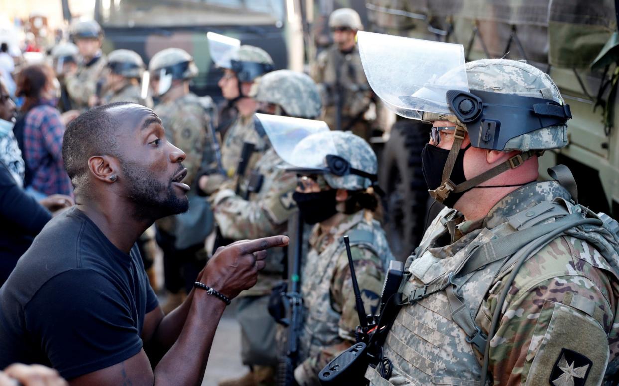 A man confronts a National Guard member during protests in Minneapolis - LUCAS JACKSON/REUTERS