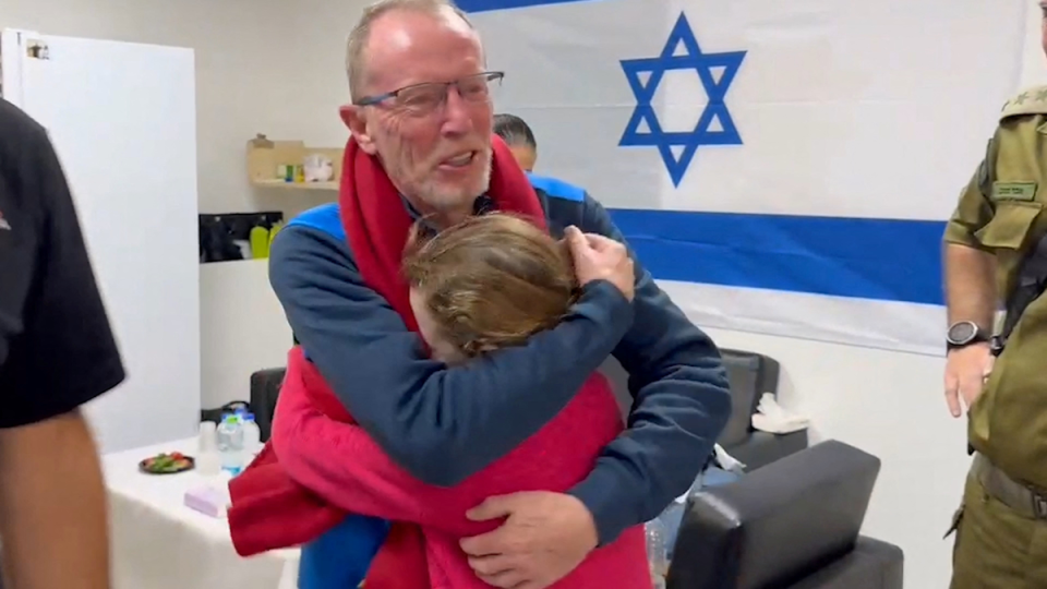 Emily Hand, who was abducted by Hamas gunmen during the October 7 attack on Israel, meets her father Thomas Hand on November 26 (via REUTERS)