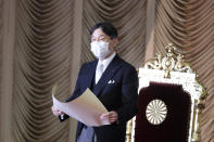 Japan's Emperor Naruhito wearing a face mask to protect against the coronavirus reads a statement to formally open an extraordinary Diet session at the upper house of parliament in Tokyo, Monday, Oct. 26, 2020. (AP Photo/Koji Sasahara)