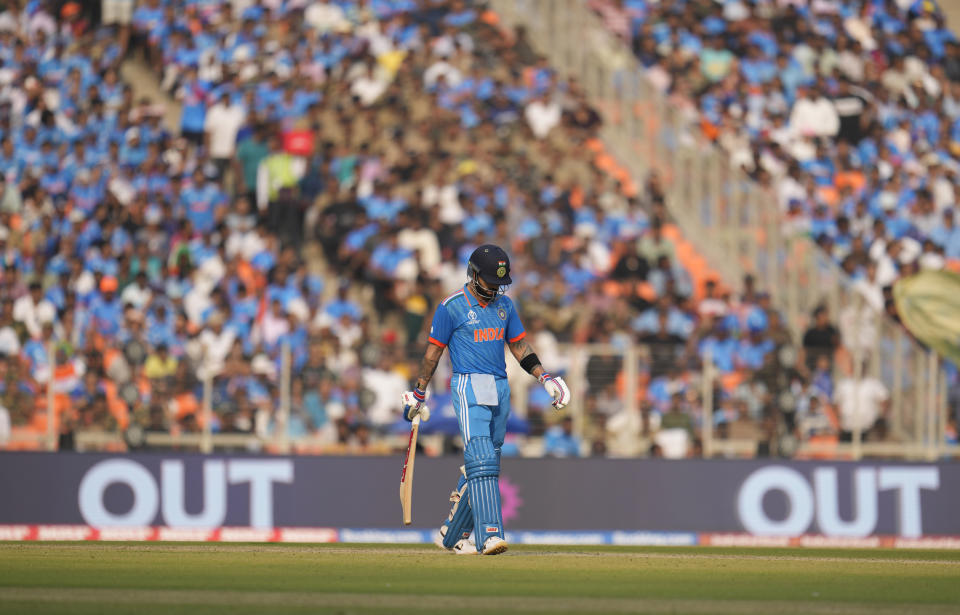 India's Virat Kohli leaves the ground after losing his wicket during the ICC Men's Cricket World Cup final match between India and Australia in Ahmedabad, India, Sunday, Nov.19, 2023. (AP Photo/Aijaz Rahi)