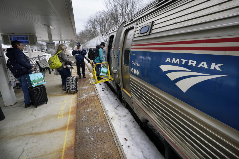 Passengers board an Amtrak Downeaster, Wednesday, March 8, 2023, in Freeport, Maine. The New Hampshire Liquor Commission says it is "exploring a creative solution" after saying an Amtrak route from Maine to Boston can't serve alcohol while passing through 35 miles of New Hampshire. (AP Photo/Robert F. Bukaty)