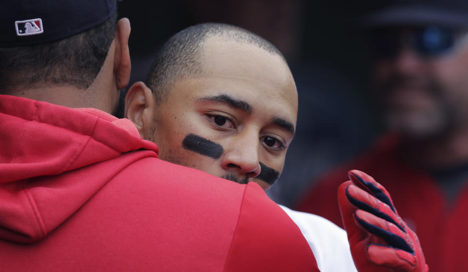 Boston Red Sox's Mookie Betts, right, is embraced by Eduardo Rodriguez after his solo home run during the seventh inning of a baseball game against the Toronto Blue Jays at Fenway Park in Boston, Thursday, July 18, 2019. (AP Photo/Charles Krupa)