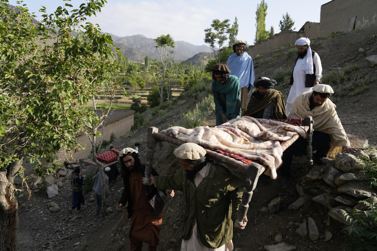 Afghans carry a relative killed in an earthquake to a burial site l in Gayan village, in Paktika province, Afghanistan, Thursday, June 23, 2022. A powerful earthquake struck a rugged, mountainous region of eastern Afghanistan early Wednesday, flattening stone and mud-brick homes in the country's deadliest quake in two decades, the state-run news agency reported. (AP Photo/Ebrahim Nooroozi)