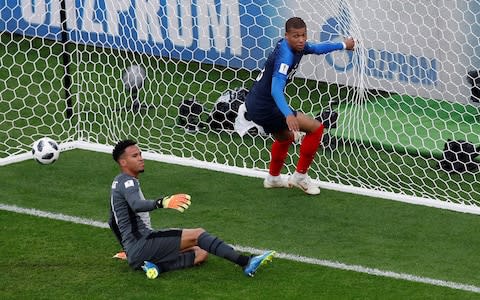 Pedro Gallese looks dejected as France's Kylian Mbappe celebrates scoring the only goal of the game - Credit:  REUTERS/Andrew Couldridge