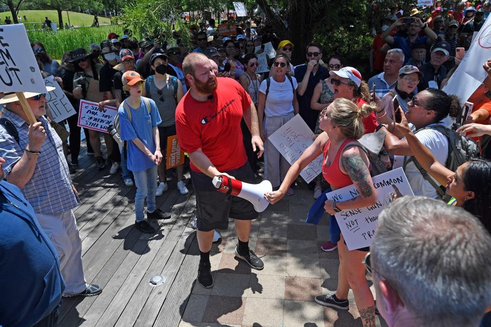 Pro and anti gun demonstrators confront each other outside the NRA convention in Houston Friday.