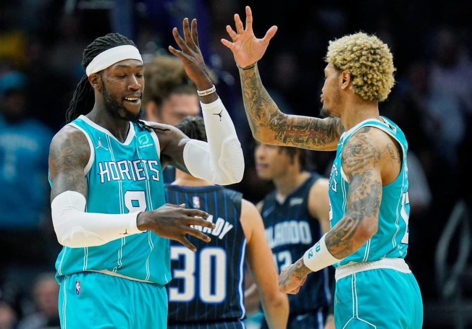 Charlotte Hornets center Montrezl Harrell, left, celebrates a basket with teammate Kelly Oubre Jr., right, during the first half of an NBA basketball game against the Orlando Magic on Thursday, April 7, 2022, in Charlotte, N.C. (AP Photo/Rusty Jones)