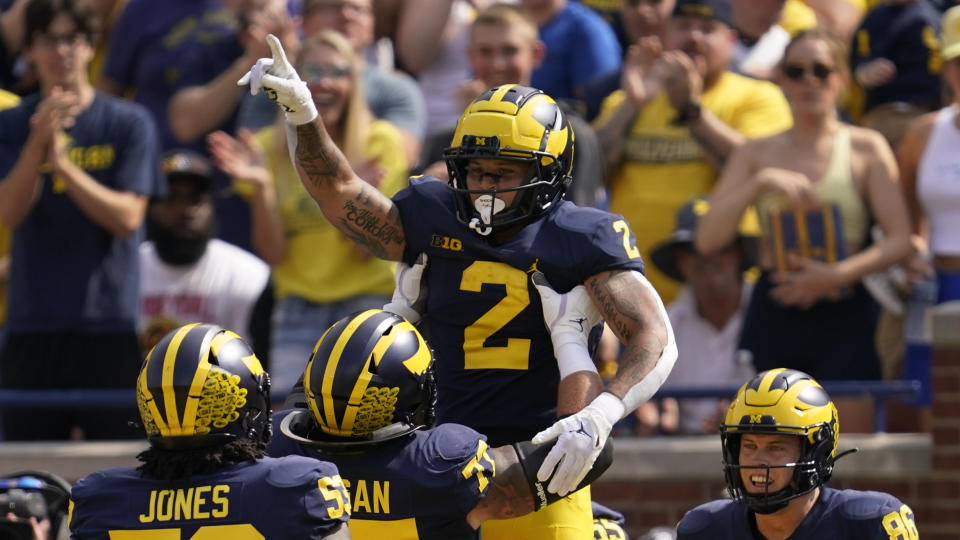 Michigan running back Blake Corum (2) celebrates his 20-yard touchdown run against Connecticut in the first half of an NCAA college football game in Ann Arbor, Mich., Saturday, Sept. 17, 2022. (AP Photo/Paul Sancya)