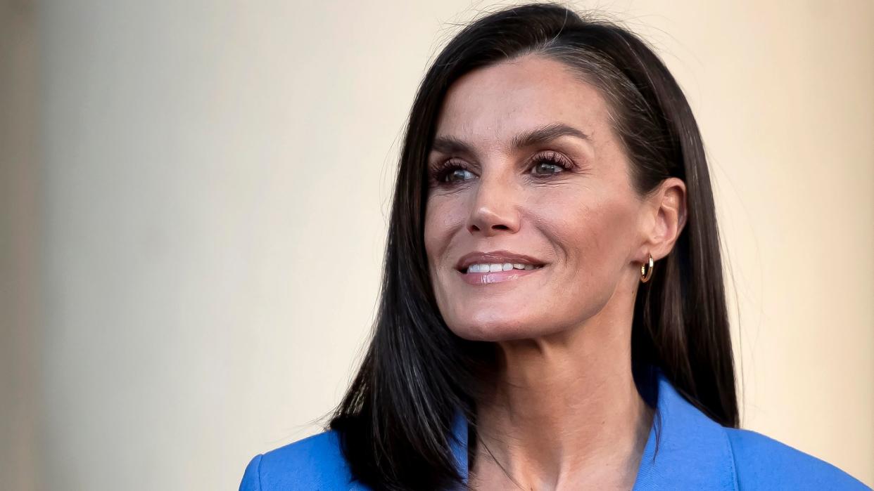 Queen Letizia smiling in blue blazer