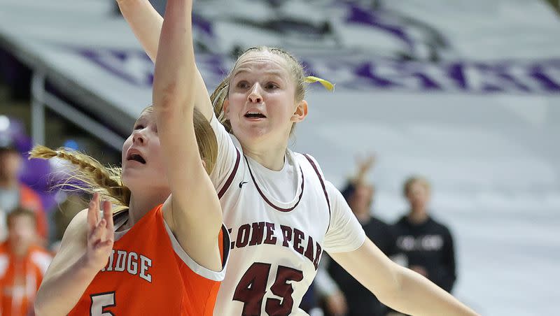 Skyridge High’s Cambree Blackham shoots as Lone Peak’s Sarah Bartholomew guards her during the 6A girls basketball championship game at the Dee Events Center in Ogden, on Saturday, March 4, 2023. Lone Peak won 64-49.