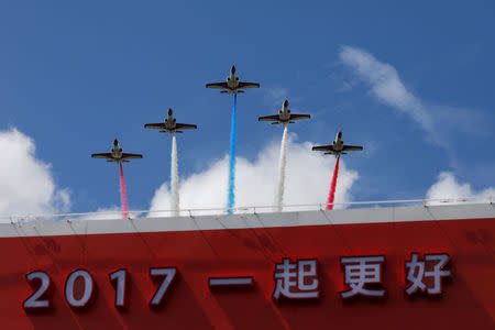 Taiwanese aerobatic fighter jet troupe "Thunder Tigers" perform during the National Day celebrations in Taipei, Taiwan, October 10, 2017. The characters read "A better 2017" . REUTERS/Tyrone Siu