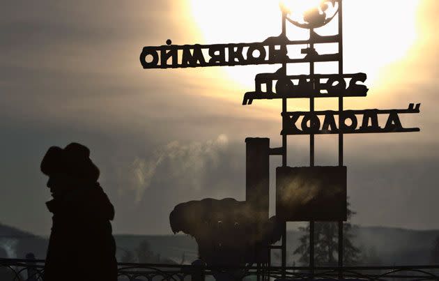 A man passes a sign saying 