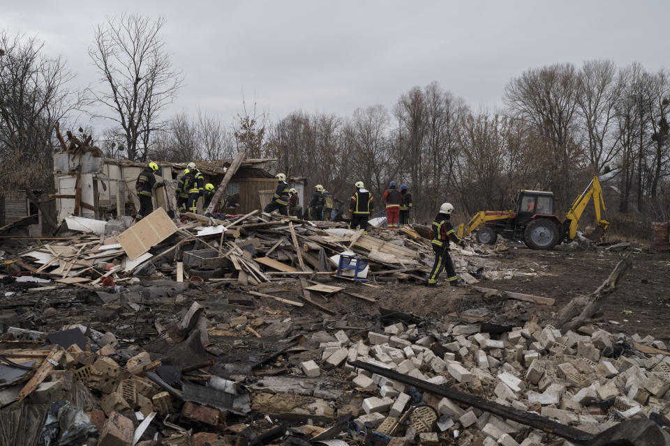 Emergency workers remove debris of a house destroyed following a Russian missile strike in Kyiv, Ukraine, Thursday, Dec. 29, 2022. (AP Photo/Roman Hrytsyna)
