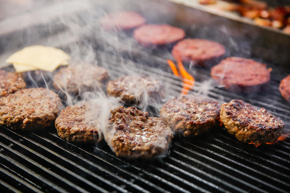 Close-up shot of grilled beef patty on the making for backyard picnic during Covid 19 pandemic.