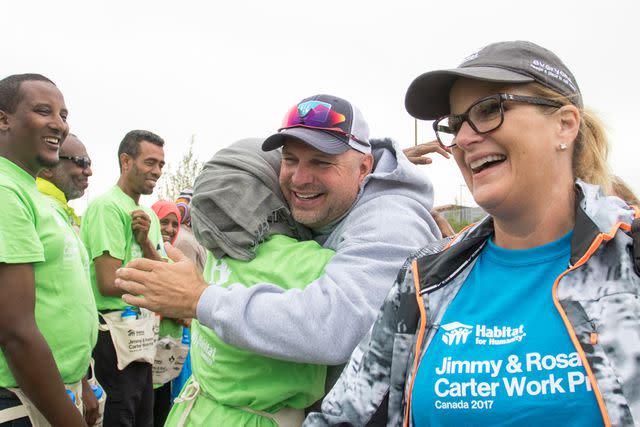 <p>Gregg Pachkowski/Habitat for Hum</p> Garth Brooks and Trisha Yearwood working with Habitat for Humanity in 2017