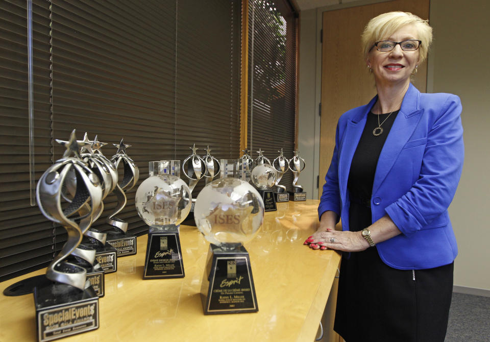 In this Friday, June 15, 2012 photo, Kathy Miller, president of Total Event Resources, poses for a photograph next to trophies awarded to her company in her offices in Schaumburg, Ill. In 2008, her events planning company was having its best year ever. She and her husband had set aside money to put their two sons through college, with enough left in savings for "a very nice life" in the Chicago suburb. Then the financial crisis sent the stock market tumbling and the corporate customers who had kept Miller's company busy, stopped calling. When the government reported that the Great Recession claimed nearly 40 percent of Americans' wealth, the figure alarmed economists. But for families across the country, the numbers merely confirm that they are not alone. (AP Photo/M. Spencer Green)