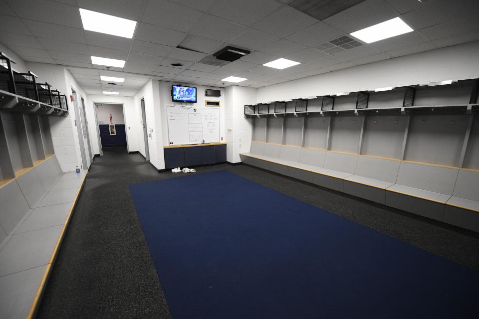 The empty visitors NHL hockey locker room is seen at Capital One Arena in Washington, Thursday, March 12, 2020. The Washington Capitals were to play the Detroit Red Wings later tonight. The NHL is following the NBA’s lead and suspending its season because of the coronavirus pandemic. NHL Commissioner Gary Bettman announced Thursday it is pausing its season, one day after the NBA suspended play after a player tested positive Wednesday for COVID-19.(AP Photo/Nick Wass)