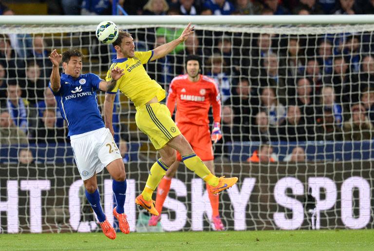 Chelsea's Branislav Ivanovic (R) jumps for a header with Leicester City's Leonardo Ulloa during the match at King Power Stadium in Leicester, central England on April 29, 2015