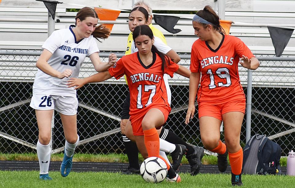 Diman's Filipa Duarte moves the ball under pressure from Bristol-Plymouth's Meghan Emond with Olivia DeMelo providing support.