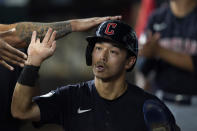 Cleveland Guardians' Steven Kwan is congratulated in the dugout after scoring on a double by teammate Josh Naylor during the sixth inning of a baseball game against the Texas Rangers in Arlington, Texas, Friday, Sept. 23, 2022. (AP Photo/LM Otero)