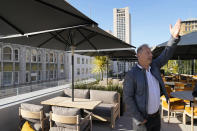 Founder Kurt Zdesar points to the surrounding view from the rooftop Chotto Matte restaurant in San Francisco, Tuesday, Oct. 24, 2023. Thousands of CEOs, press, world leaders, protesters and others will descend on San Francisco for a global trade summit that could give the much maligned city a chance to shine. City officials herald the late October opening of Chotto Matte, a high-end global restaurant chain serving up Japanese Peruvian food and cocktails, in a stunning rooftop location atop what was once downtown Macy's department store for men. (AP Photo/Eric Risberg)