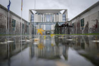 Leaves blowing in the wind across the forecourt in front of the Federal Chancellery in Berlin, Germany, during the federal states meeting on the Corona Pandemic, Tuesday, Nov. 30, 2021. (Kay Nietfeld/dpa via AP)