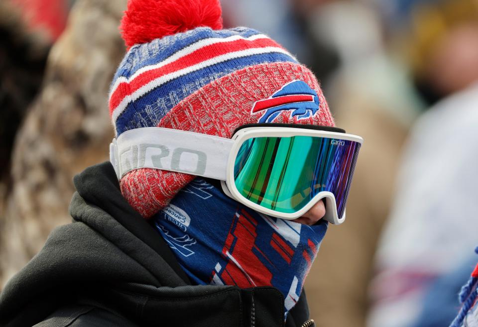 A bundled up fan fights the cold at Highmark Stadium.