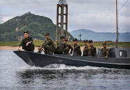 <p>North Korean soldiers ride on a boat used as a local ferry as they cross the Yalu river north of the border city of Dandong, Liaoning province, northern China near Sinuiju, North Korea on May 23, 2017 in Dandong, China. (Photo: Kevin Frayer/Getty Images) </p>