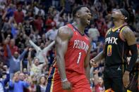 New Orleans Pelicans forward Zion Williamson (1) celebrates next to Phoenix Suns forward Torrey Craig (0) after dunking in the second half of an NBA basketball game in New Orleans, Friday, Dec. 9, 2022. (AP Photo/Matthew Hinton)