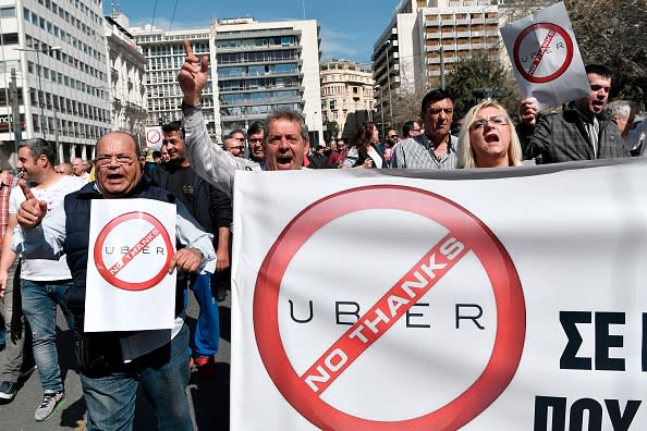 Greek taxi drivers chant slogans during a protest in central Athens on March 6, 2018 against the UBER (Tourism Vehicle with Driver VTC) text to be voted in parliament. Uber operates in over 600 cities worldwide, facing widespread resistance including from taxi driver unions that accuse them of unfair competition. (Photo credit LOUISA GOULIAMAKI/AFP/Getty Images)